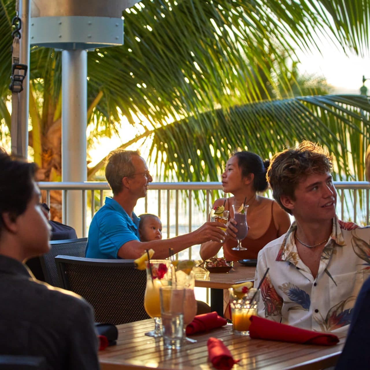 Couple eating food Tiki's golden hour palm trees