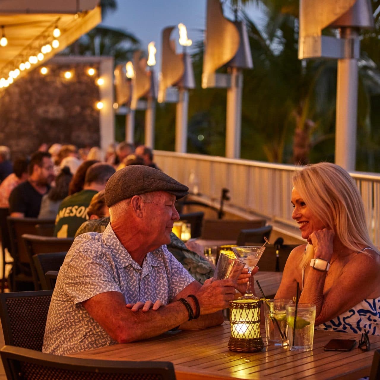 Couple enjoying drinks on lanai