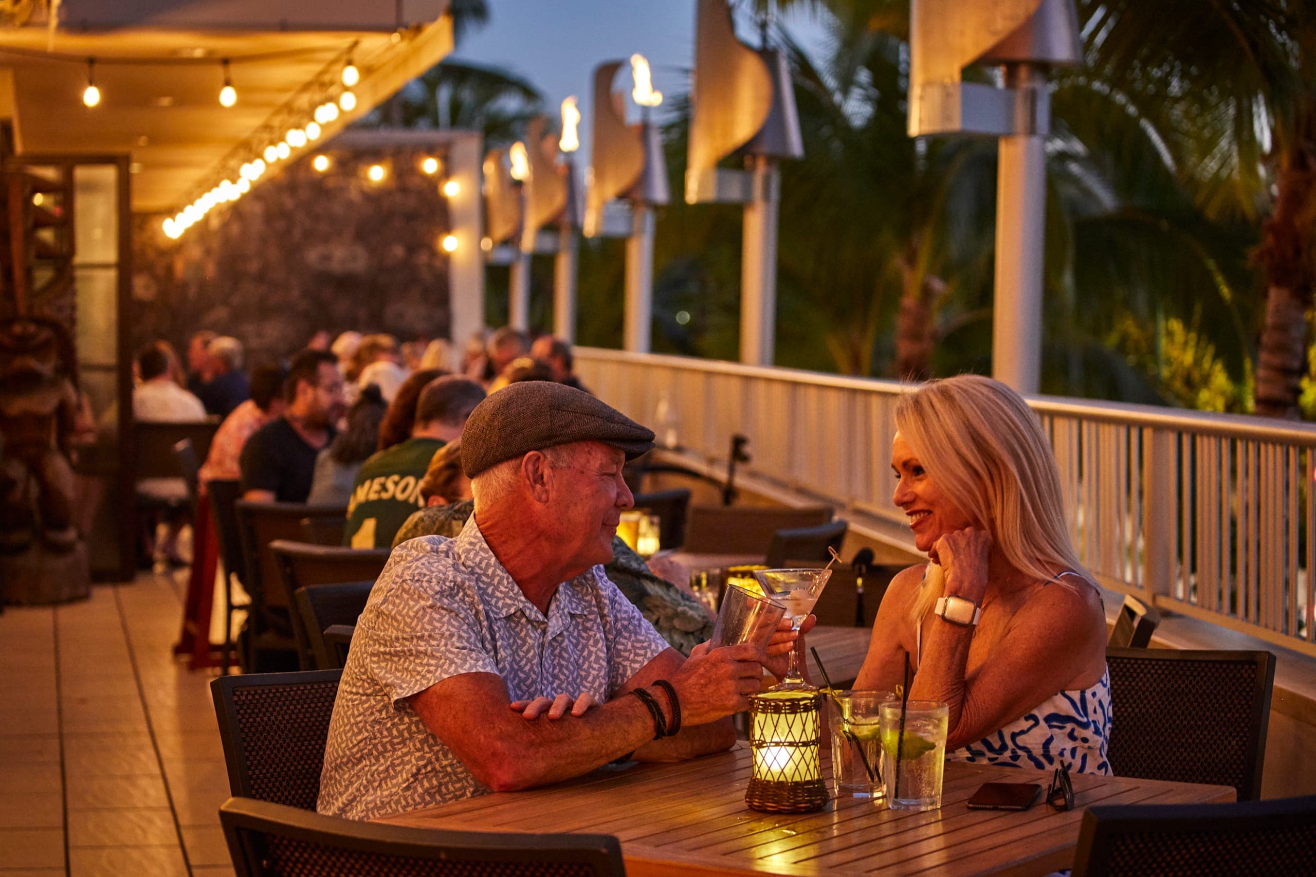 Couple enjoying drinks on lanai