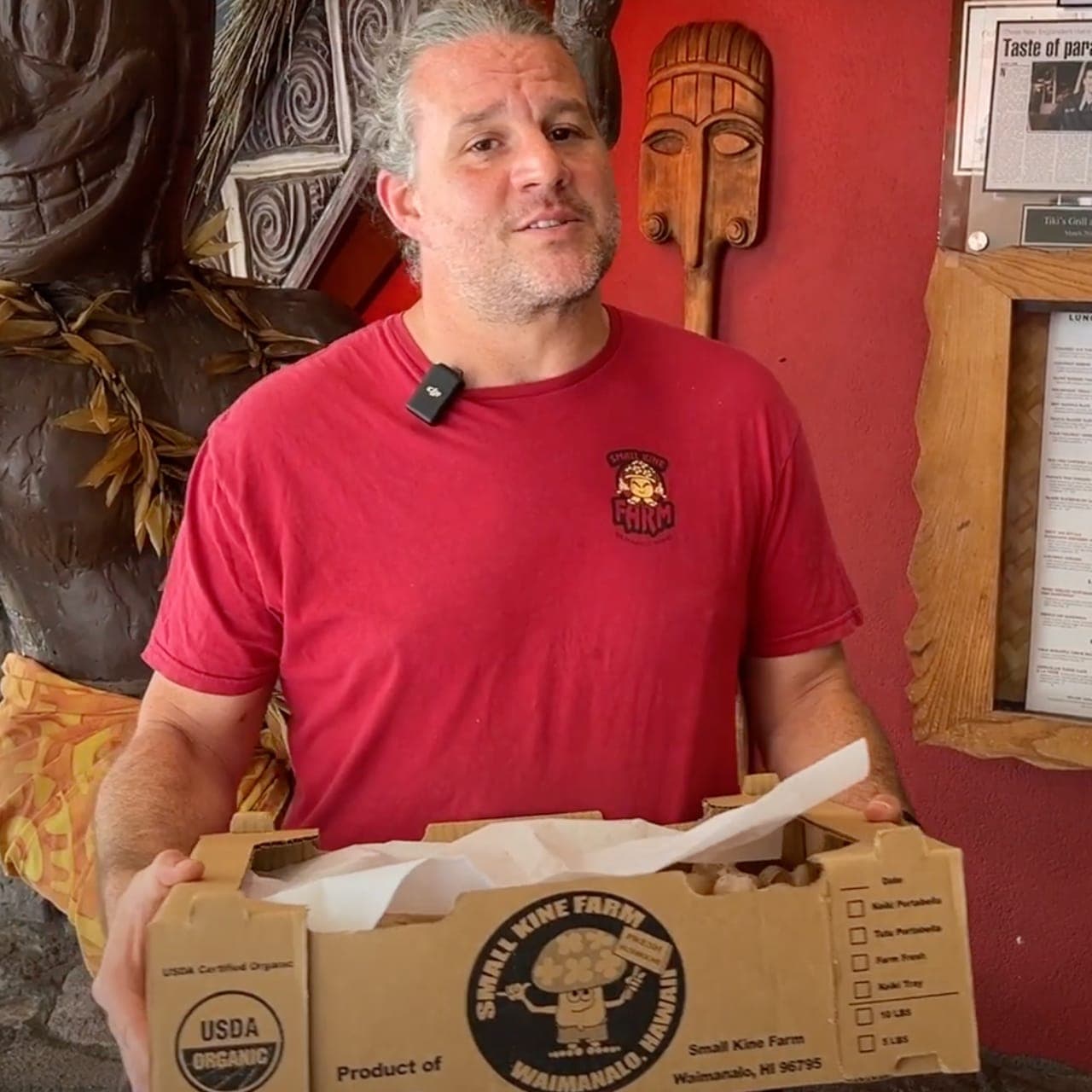 Zach from Small Kine Farm delivering fresh organic crimini mushrooms to Tiki's Grill & Bar, showcasing a commitment to local, sustainable ingredients.