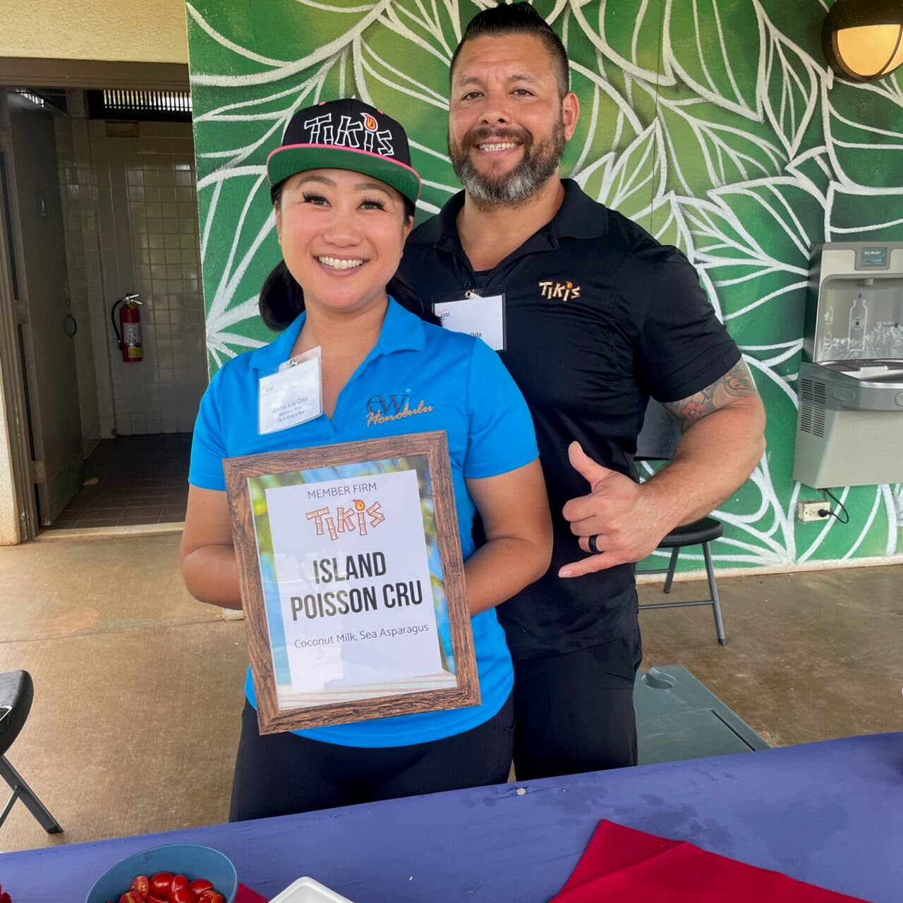Tiki’s Grill & Bar team members Jenni and Matt Oda volunteering at the EWI Golf Tournament, representing the restaurant through their donation of food and service.