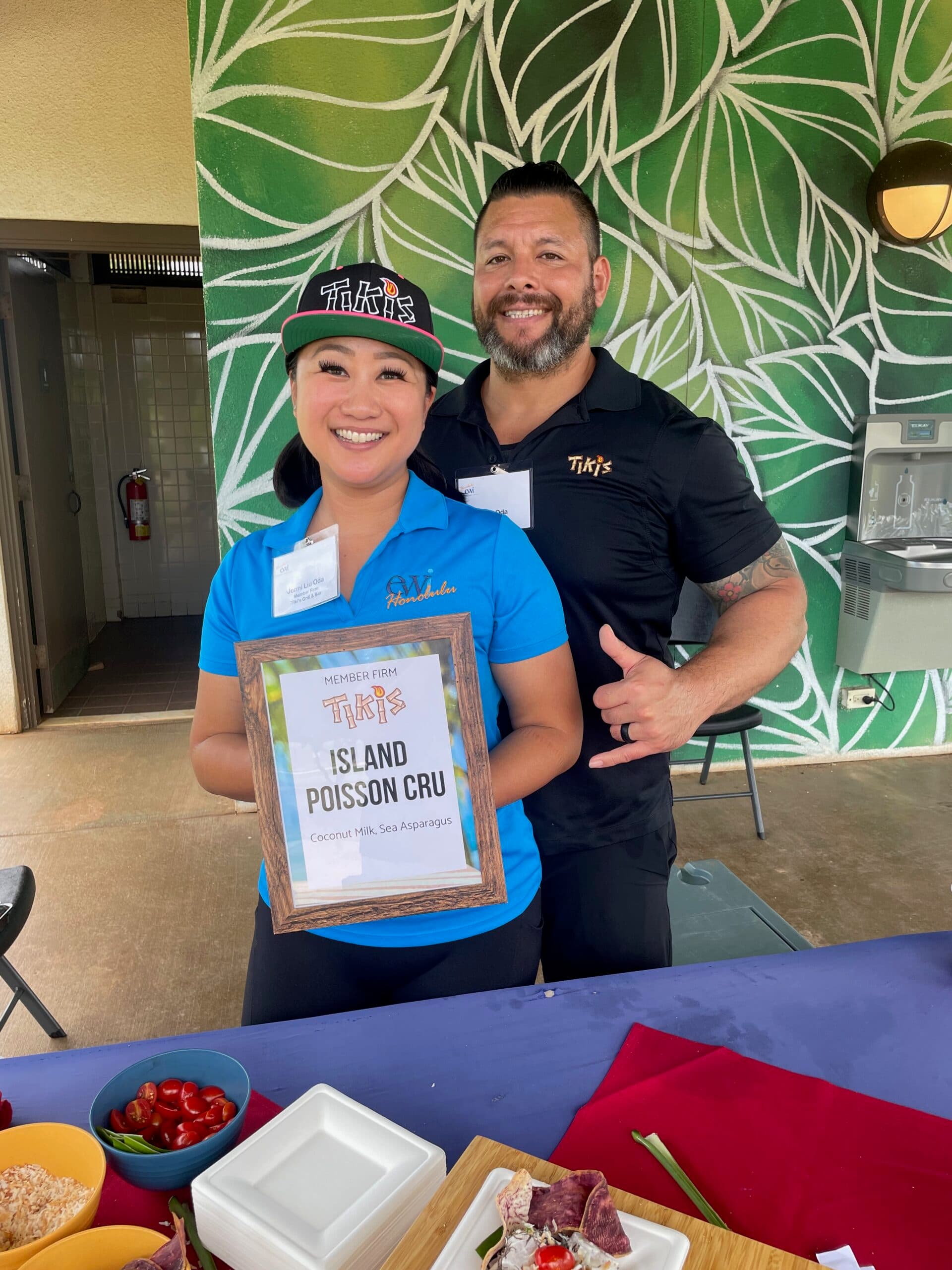Tiki’s Grill & Bar team members Jenni and Matt Oda volunteering at the EWI Golf Tournament, representing the restaurant through their donation of food and service.