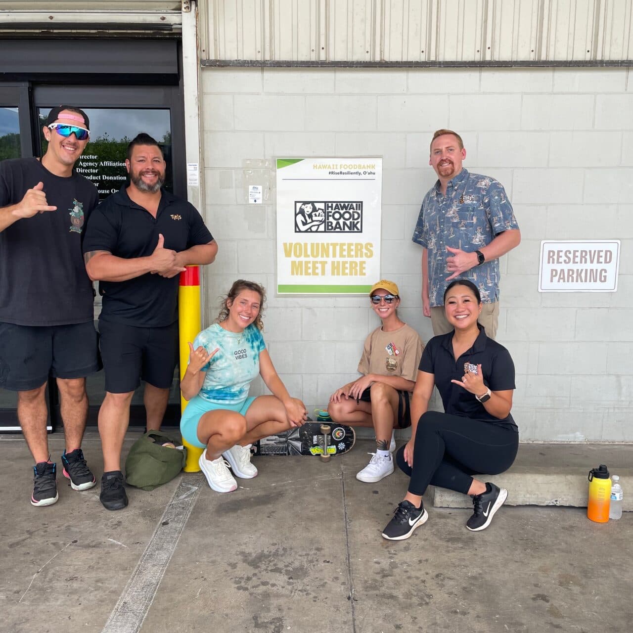 Tiki’s Grill & Bar ohana team stands together outside the Hawai‘i Foodbank in Honolulu, ready to volunteer and support the community.