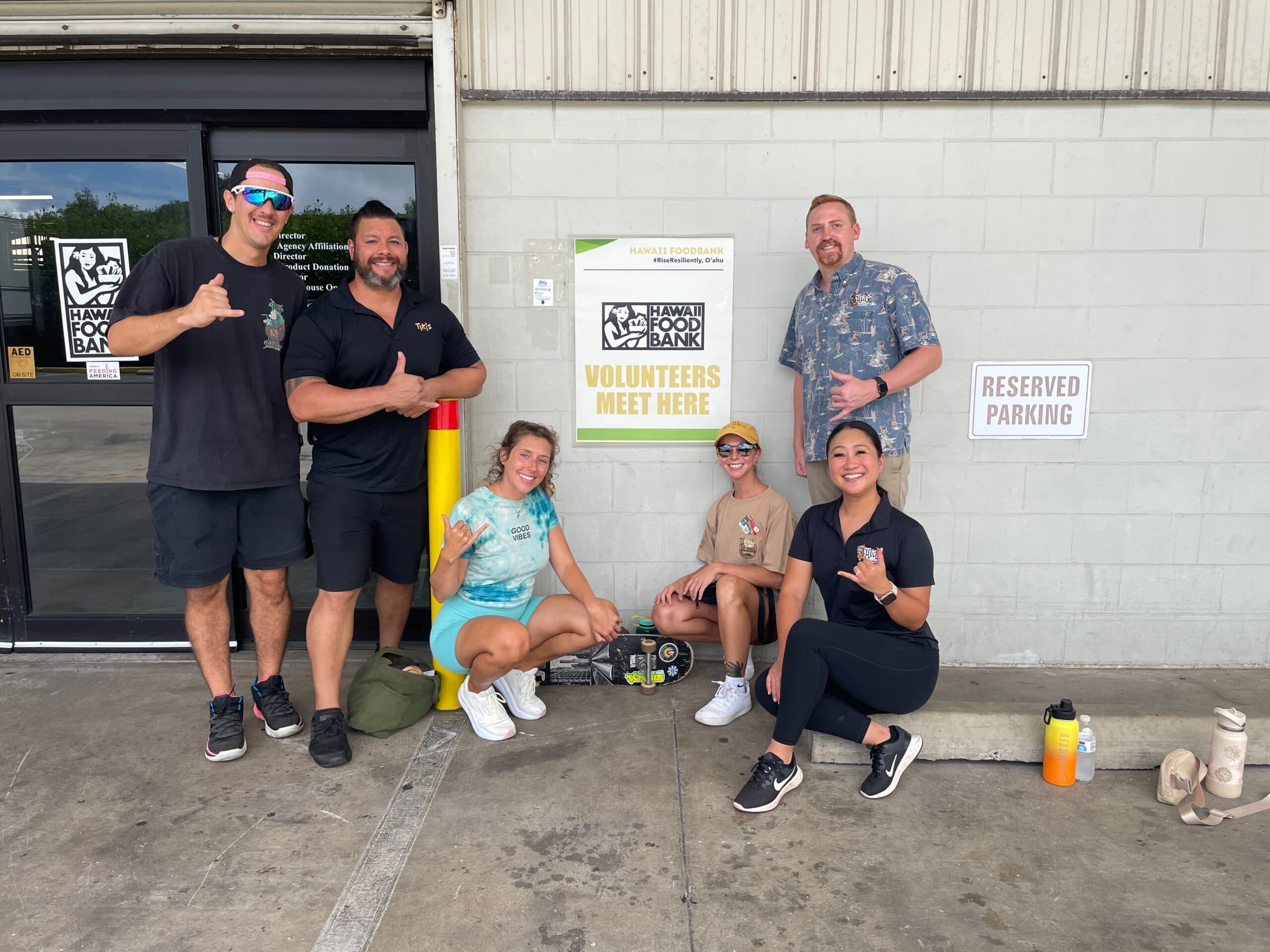 Tiki’s Grill & Bar ohana team stands together outside the Hawai‘i Foodbank in Honolulu, ready to volunteer and support the community.