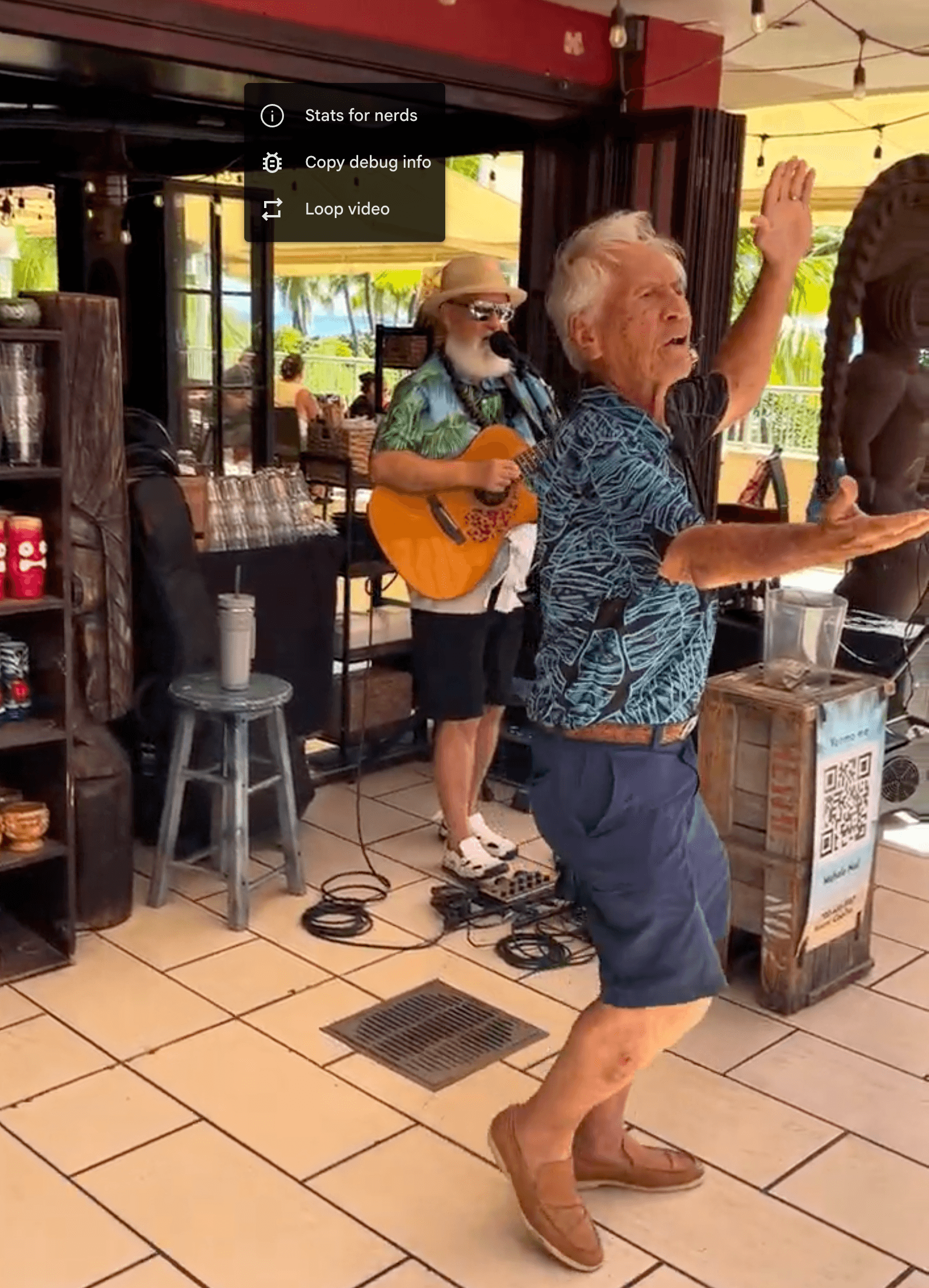 Kimo Kahoano performing a traditional Hawaiian hula at Tiki’s Grill & Bar in Waikīkī, bringing island culture to life.